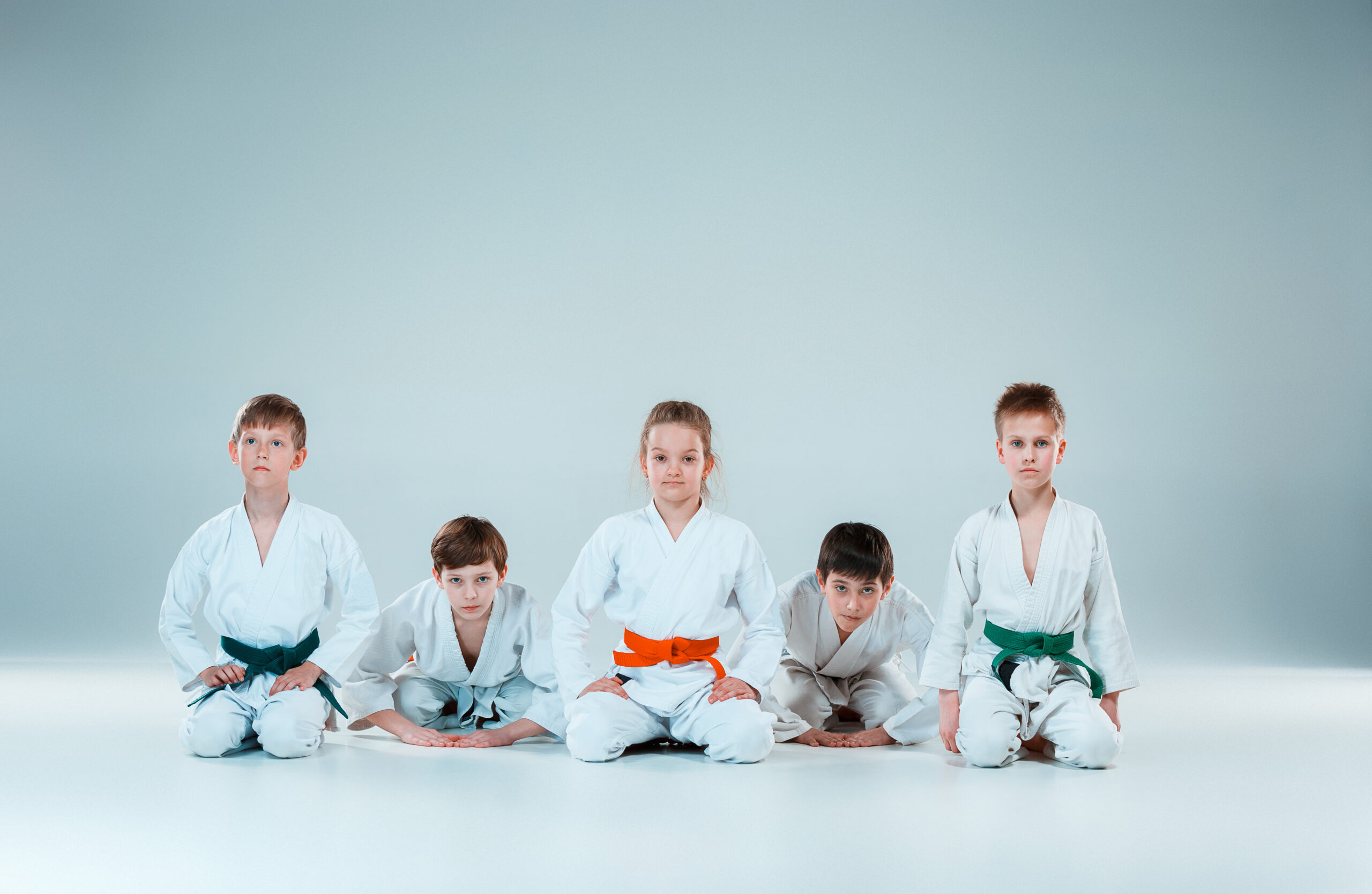 The group of boys and girl fighting at Aikido training in martial arts school. Healthy lifestyle and sports concept